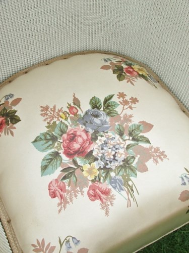 White wicker chair with pretty floral seat